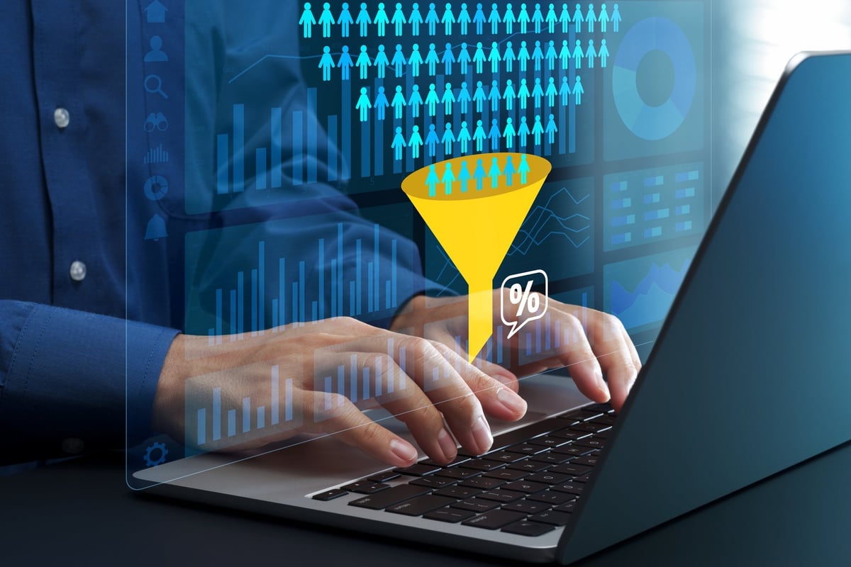 Marketer reviewing customer behavioral data on a laptop to find where visitors drop off